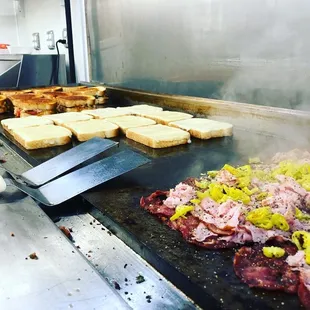 the meat being cooked on the grill