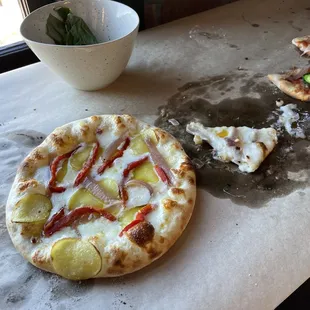 Handmade pizzas from our pizza making class.  Thin potato &amp; sweet potato slices, plus their rose-sautéed onions, made for a delicious combo