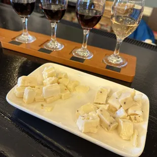 Wine flight and some cheeses purchased in-shop (bartender packaged the rest for us)