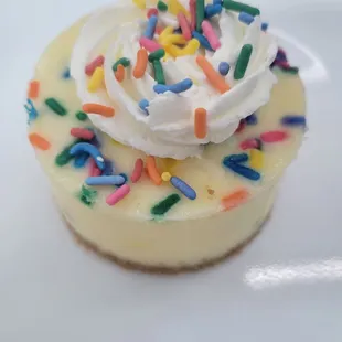 a cupcake with whipped cream and sprinkles