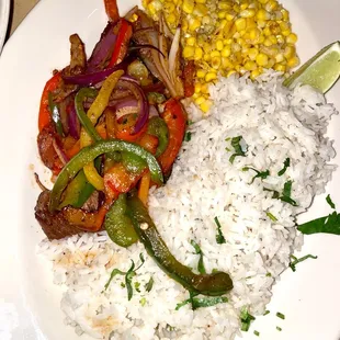 Carne Asada Steak- steak medallions covered with sautéed peppers, onions, cilantro, serve with creamy ranchero sauce, fresh corn &amp; rice