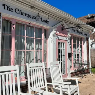 two white rocking chairs outside