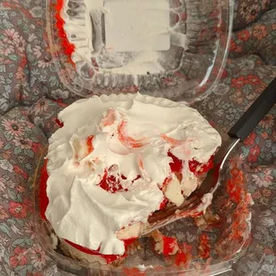 a strawberry cheesecake with whipped cream and whipped cream