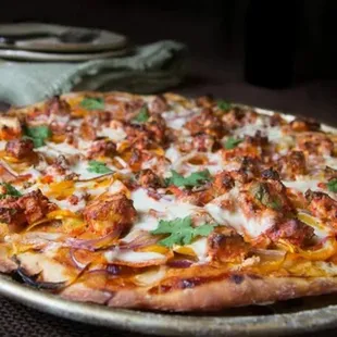 a pizza with meat and cheese
