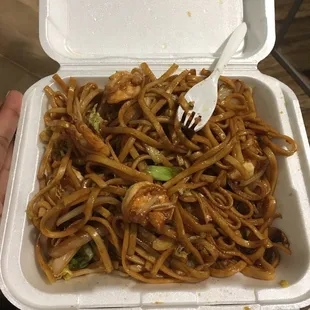 a take out container of noodles