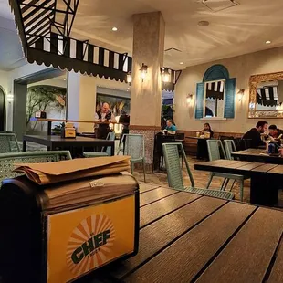 people sitting at tables in a restaurant