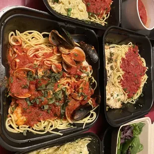 four trays of spaghetti and clams