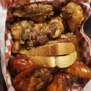 a basket of wings and hot dogs