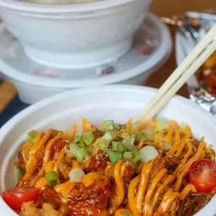 a bowl of noodles and chopsticks