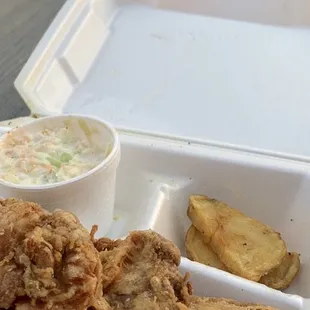 Eating my food outside by the lake. So delicious. Chicken with broasted potatoes and coleslaw.  Delicious