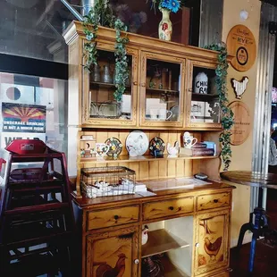 a wooden hutch with a glass door