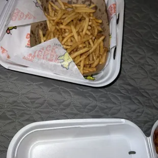 a tray of fries and a container of ketchup