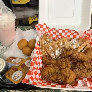 a tray of fried chicken and waffles