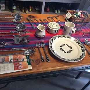 a table set with silverware and utensils