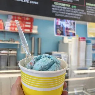 Kids cotton candy hard pack ice cream in a cup.