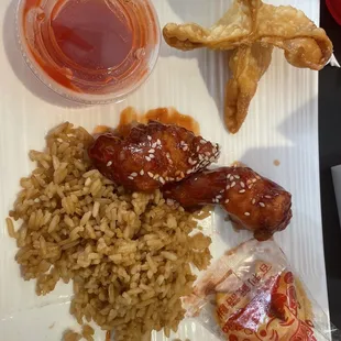 A few pieces of sesame chicken, fried rice, crab ragoon and a fortune cookie.