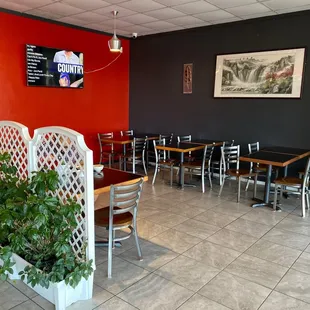 a dining area with tables and chairs