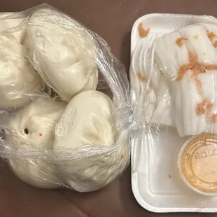 a tray of chinese noodle rolls and a container of chinese noodle rolls