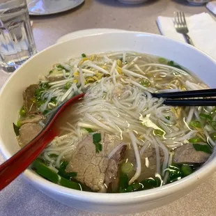 a bowl of soup and chopsticks
