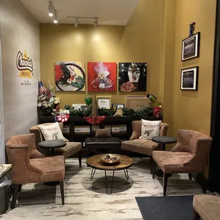 a living room with a couch, chairs, and coffee table