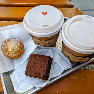 Two hot chocolates: one classic and one Mexican spicy, brownie, and a tea cake.
