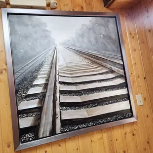 a picture of a train track and exit sign