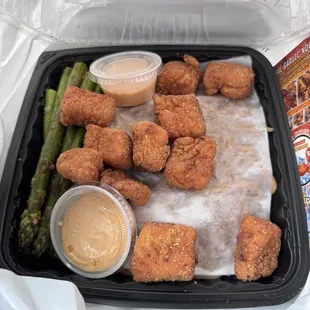 Fried salmon bites, asparagus, garlic noodles and sauce