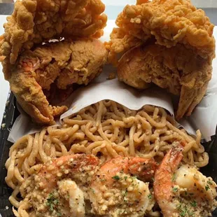 Twin fried lobsters with simmer sautéed shrimp over garlic noodles