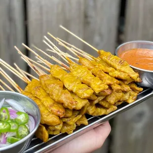 a person holding a tray of food