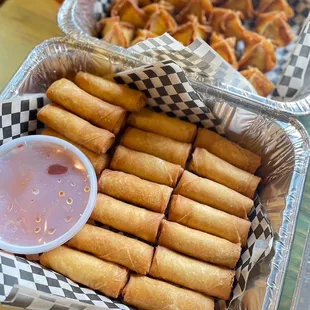 a tray of fried food with dipping sauce