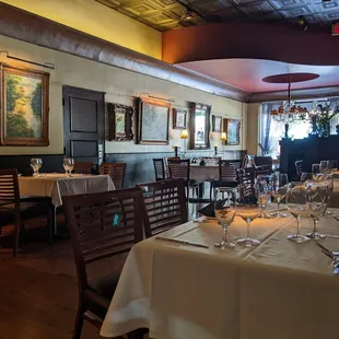 Elegant dining room, from the light fixtures to the detailed ceiling to the eclectic artwork. Such a great place to dine.