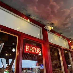 a neon sign for burgers
