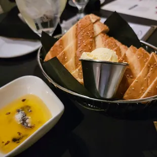 a basket of bread and dipping sauce