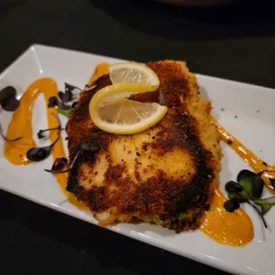 a plate of food with a lemon slice on top