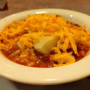 a bowl of chili and cheese