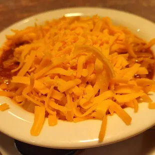 a bowl of chili and cheese
