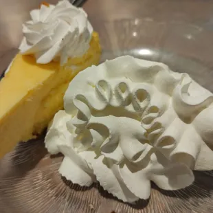 a slice of cheesecake and whipped cream