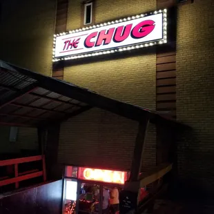 a neon sign on the side of a building