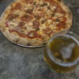 a pizza and a glass of beer