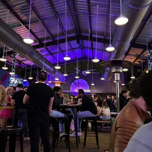 people sitting at tables in a restaurant