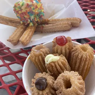 a plate of churros and a cup of coffee
