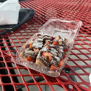 Churro Bites with Nutella, powdered sugar and fresh strawberries.