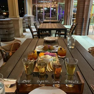 a wooden table with a platter of food on it