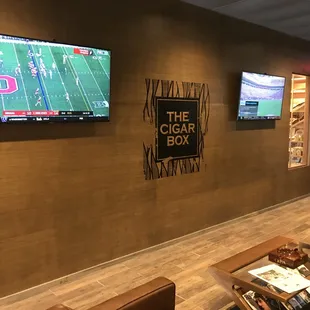 Two of three TVs in two separate seating areas.