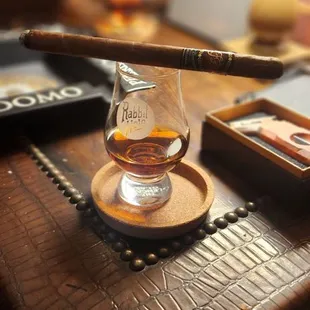 a cigar and a glass of whiskey