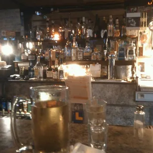 a glass of beer on a bar counter