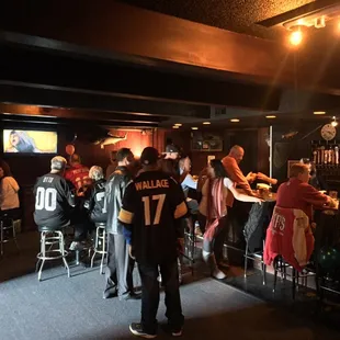 a group of people sitting at the bar