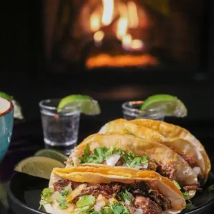 Tacos and tequila shots near the fireplace in the lounge