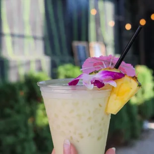 a hand holding a drink