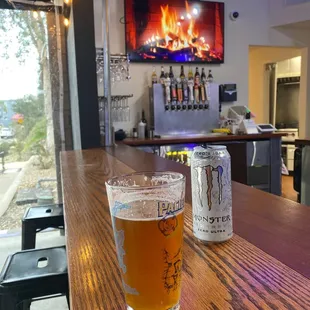 a glass of beer on a bar